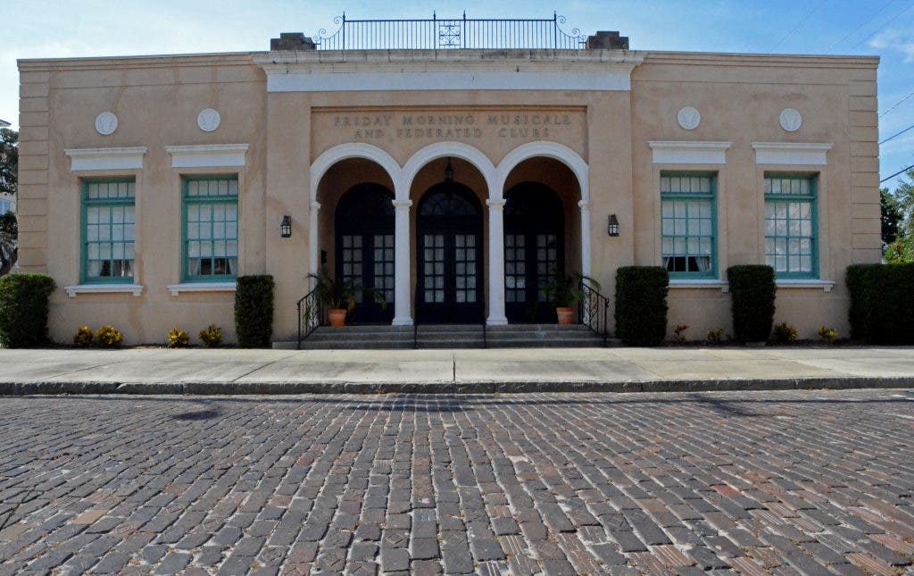 Straight-on exterior view from across the brick street.