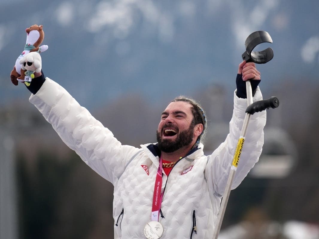 Patrick Halgren, of the United States, celebrates on the podium after winning the silver medal in the alpine skiing men's super-G standing at the 2026 Winter Paralympics, in Cortina d'Ampezzo, Italy, Monday. 