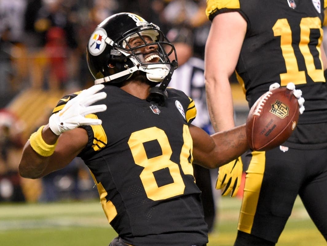 Pittsburgh Steelers wide receiver Antonio Brown celebrates after catching a touchdown pass from quarterback Ben Roethlisberger during the first half of an NFL football game against the New England Patriots in Pittsburgh, Sunday, Dec. 16, 2018.