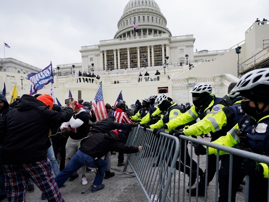 In this Jan. 6, 2021 file photo, violent rioters try to break through a police barrier at the Capitol in Washington. 