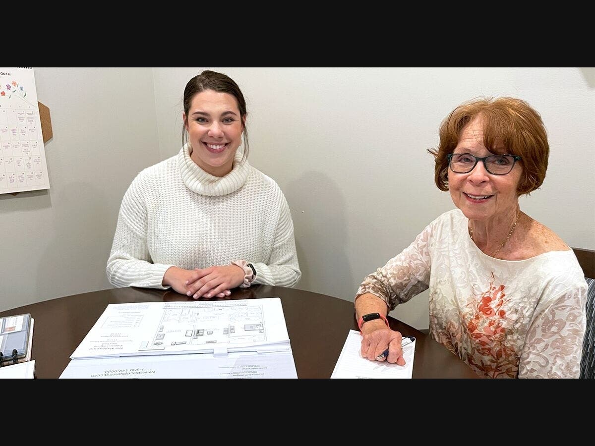 Sales Associate Jacquelyn Weir (left) meets with Vicki Frichtel to finalize the details of Vicki’s new apartment home at Avery Point.
