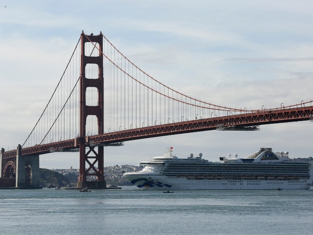The Grand Princess cruise ship passes beneath the Golden Gate Bridge in this view from Sausalito, Calif., Monday, March 9, 2020.  