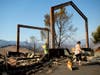 Stephanie LaFranchi, right, and Ashley LaFranchi examine the remains of their family's Oak Ridge Angus ranch, leveled by a wildfire called Kincade Fire, in Calistoga, Calif., on Monday, Oct. 28, 2019.