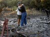 Justo and Bernadette Laos hug while looking through the charred remains of the home they rented destroyed by the Kincade Fire near Geyserville, Calif., Thursday, Oct. 31, 2019. The fire started Oct. 23 near the town of Geyserville in Sonoma County.