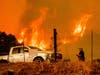 Jerry Kuny makes a phone call as flames from the LNU Lightning Complex fires approach, Tuesday, Aug. 18, 2020, in Napa County, Calif. 
