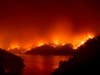 Flames from the LNU Lightning Complex fires burn around Lake Berryessa in unincorporated Napa County, Calif., on Wednesday, Aug. 19, 2020.