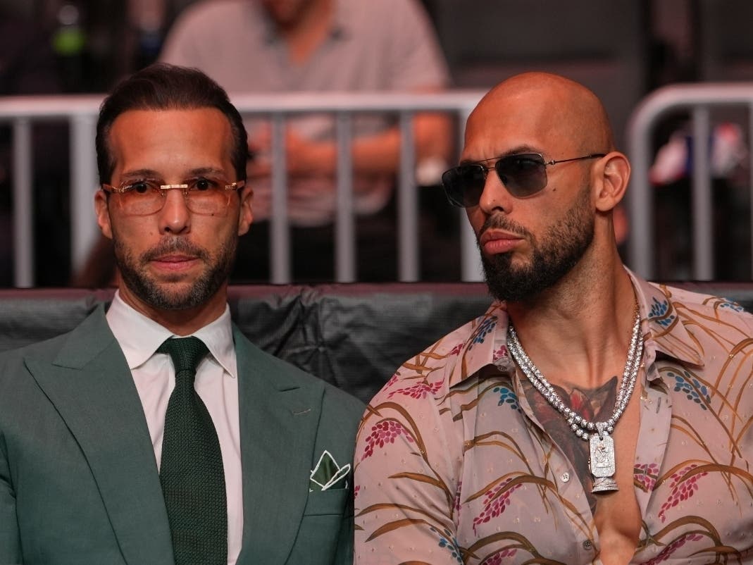 Tristan Tate (left) and Andrew Tate, here arriving at an event in Miami on April 11, were arrested Saturday by U.S. Marshals and face extradition to Britain to face rape and sex trafficking charges there.
