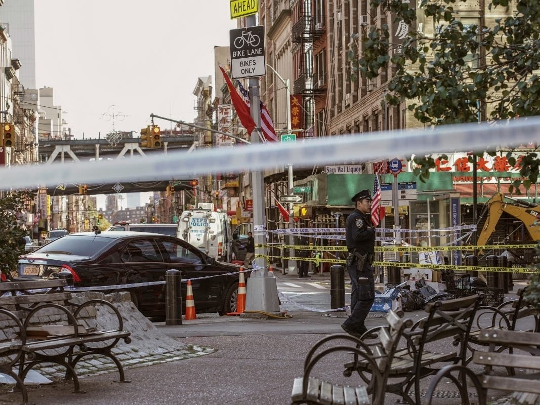 New York police investigate the scene of an attack in Manhattan's Chinatown neighborhood on Saturday.