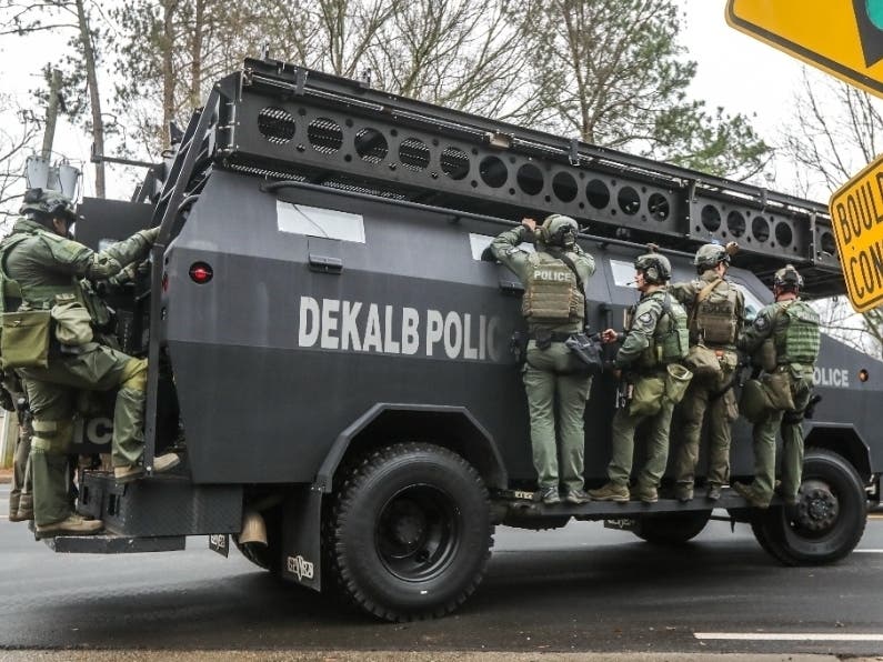 DeKalb and Atlanta SWAT members are leaving the Gresham Park command post in Atlanta on Jan. 18. Georgia state troopers helping conduct a "clearing operation" at the site of the planned public safety training center exchanged gunfire with a protester.