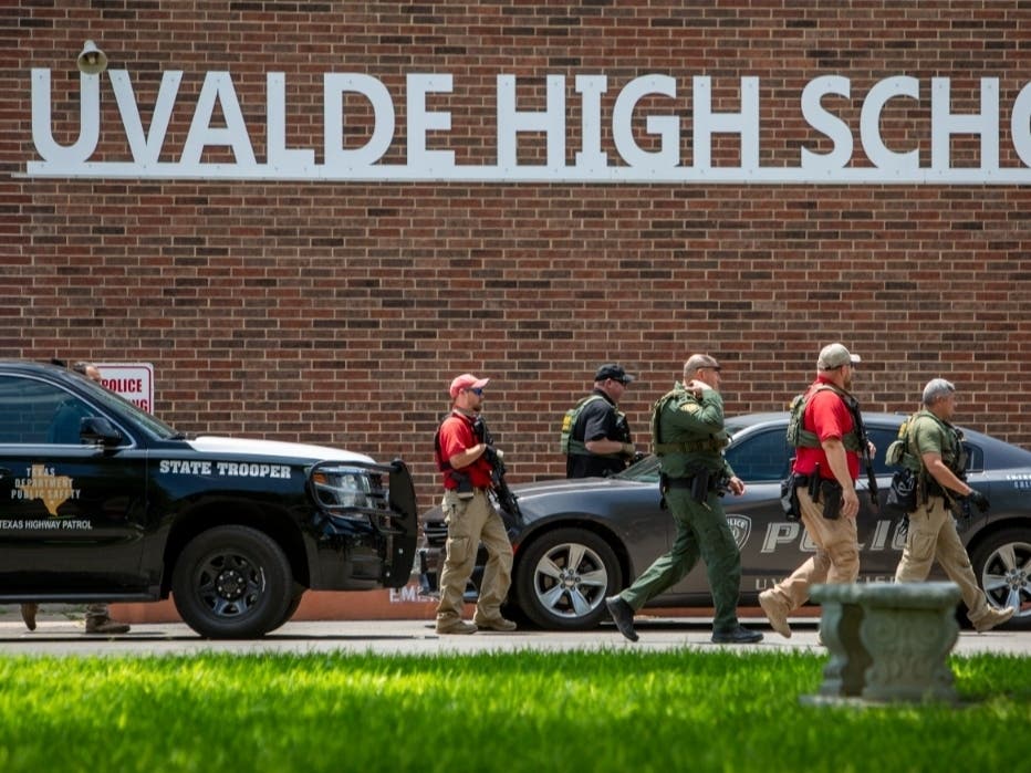 Law enforcement personnel walk outside Uvalde High School after shooting a was reported earlier in the day at Robb Elementary School, Tuesday, May 24, 2022, in Uvalde, Texas.