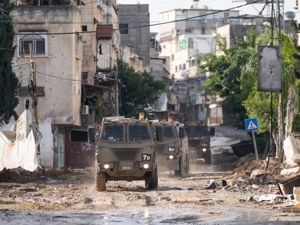 Israeli military vehicles are seen in the town of Tulkarem, West Bank, Wednesday, Nov. 22, 2023.