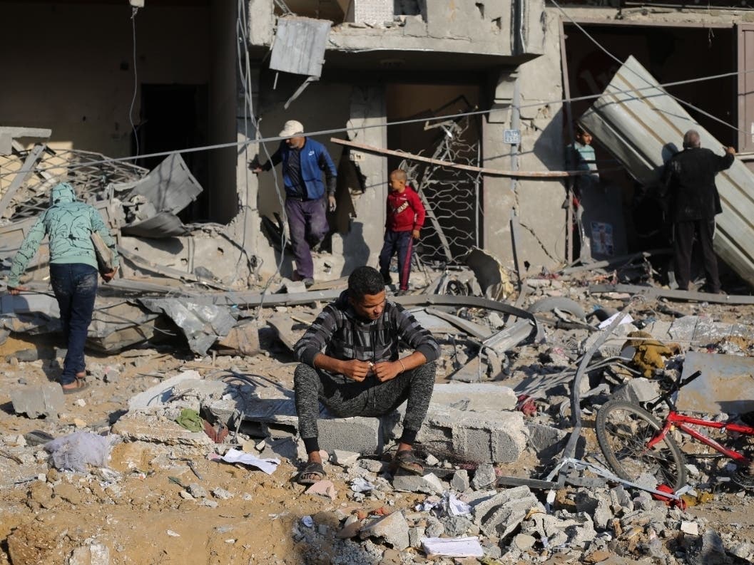 Palestinians look at the destruction caused by the Israeli bombardment of the Gaza Strip in Rafah, Monday, Dec. 4, 2023.