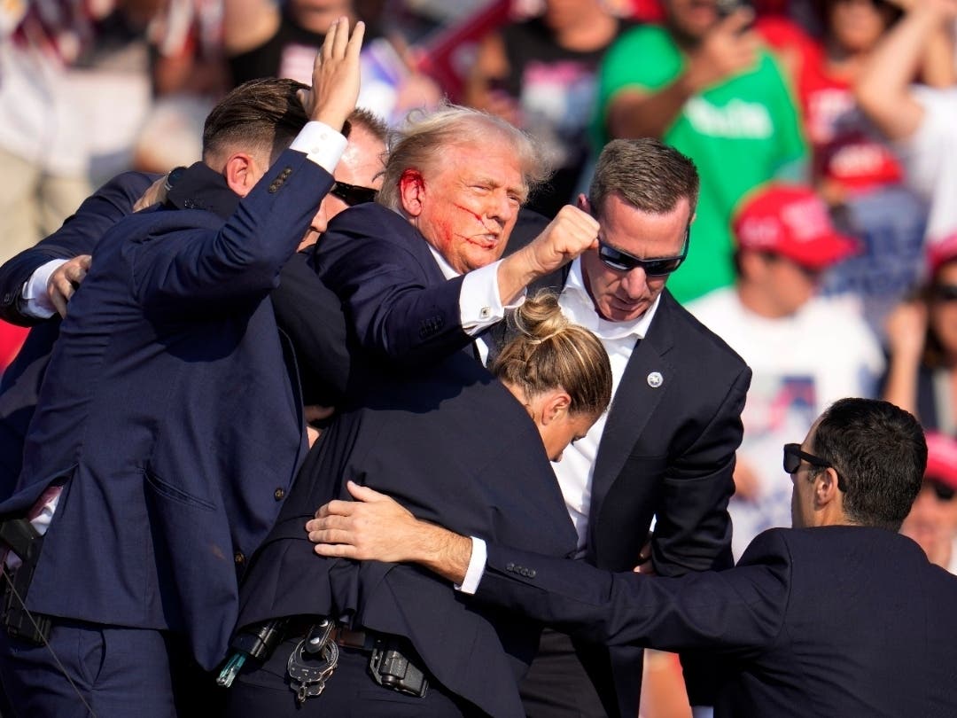 Republican presidential candidate former President Donald Trump is helped off the stage at a campaign event in Butler, Pa., on Saturday, July 13, 2024.