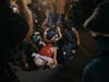 Protesters and media are thrown on the road by ICE agents outside the Delaney Hall detention during a protest on Wednesday, May 27, 2026, in Newark, N.J.