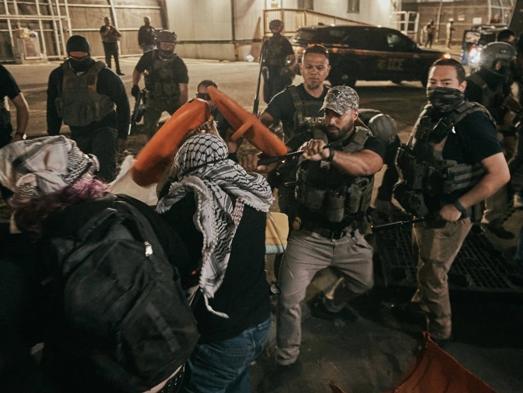 Protesters clash with ICE agents outside the Delaney Hall detention center while demonstrating near the entrance gates, Wednesday, May 27, 2026, in Newark, N.J.