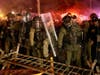 Police pass over a barricade as they clash with protesters near the Delaney Hall detention center during a protest against the transfer of detainees and federal immigration policies on Saturday, May 30, 2026, in Newark, N.J.