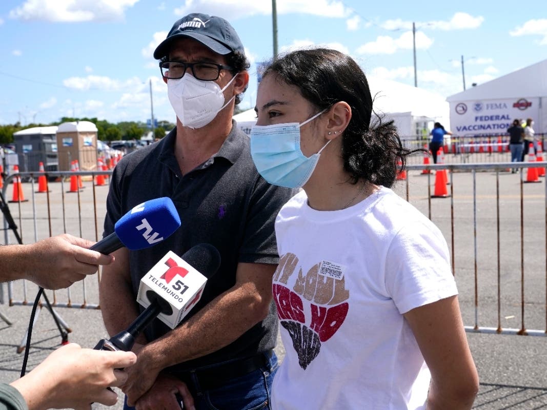 A 16-year-old Florida girl is interviewed with her father after she received the Pfizer vaccine in Miami on April 5.