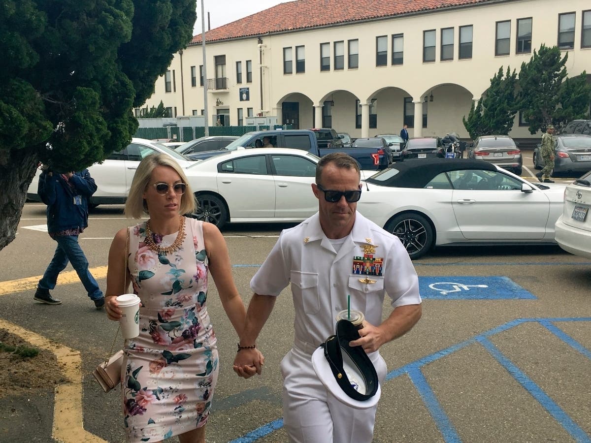 Navy Special Operations Chief Edward Gallagher, right, walks with his wife, Andrea Gallagher.