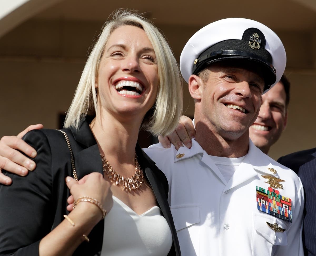 Navy Special Operations Chief Edward Gallagher, left, and his wife, Andrea Gallagher smile after leaving a military court on Naval Base San Diego.
