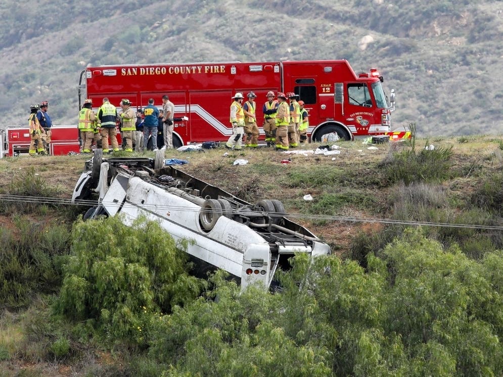 A bus rolled down an embankment off Interstate 15 in North San Diego County Saturday, Feb. 22, 2020, killing several people and injuring others. Emergency crews rescued several people trapped in the wreckage after the bus crashed.