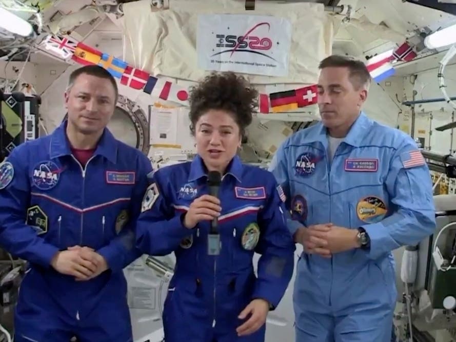U.S. astronaut Jessica Meir speaks, accompanied by Andrew Morgan and Chris Cassidy, during a news conference held by the American members of the International Space Station on Friday, April 10, 2020.