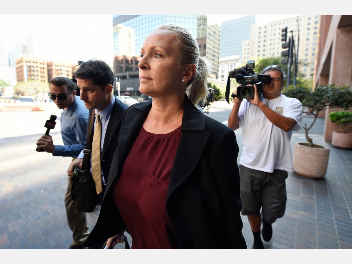 Margaret Hunter, center, the wife of U.S. Rep. Duncan Hunter, arrives for an arraignment hearing Thursday, Aug. 23, 2018, in San Diego.