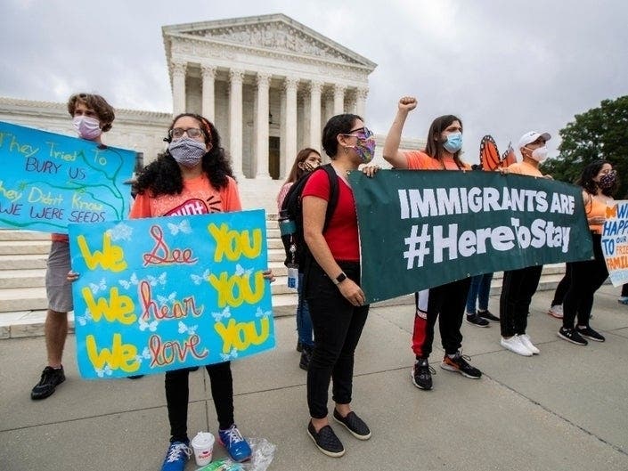 Deferred Action for Childhood Arrivals (DACA) students celebrate in front of the U.S. Supreme Court after the Supreme Court rejected President Donald Trump's bid to end legal protections for young immigrants.