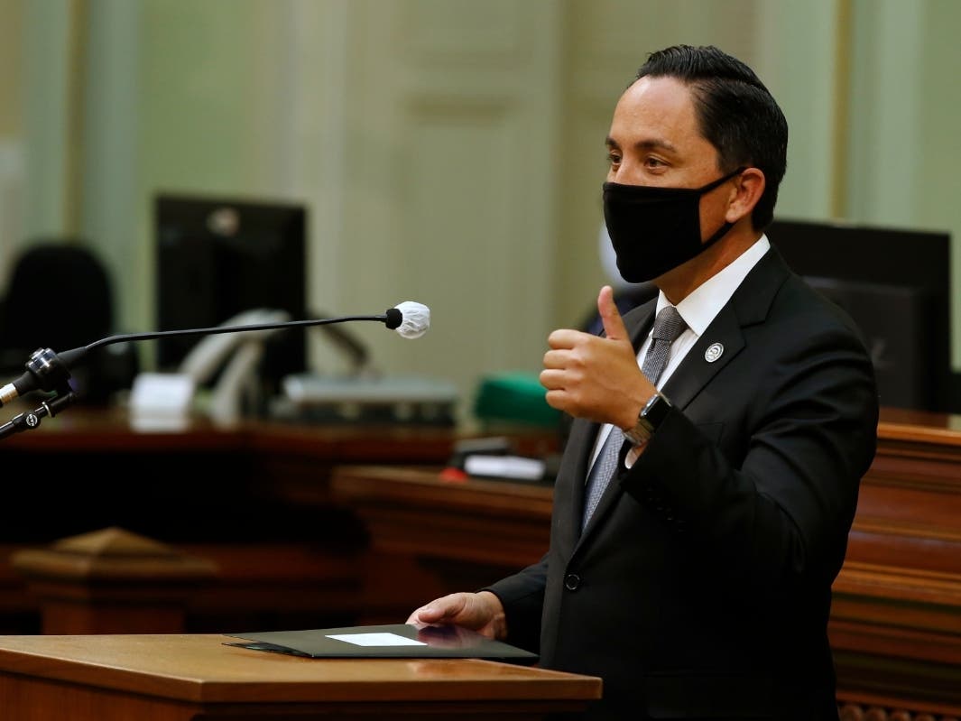 In this Monday, June 8, 2020, file photo, Assemblyman Todd Gloria, D-San Diego, gives a thumbs-up as he asks lawmakers to approve his measure to increase mental health funding for the homeless, at the Capitol in Sacramento, Calif. 