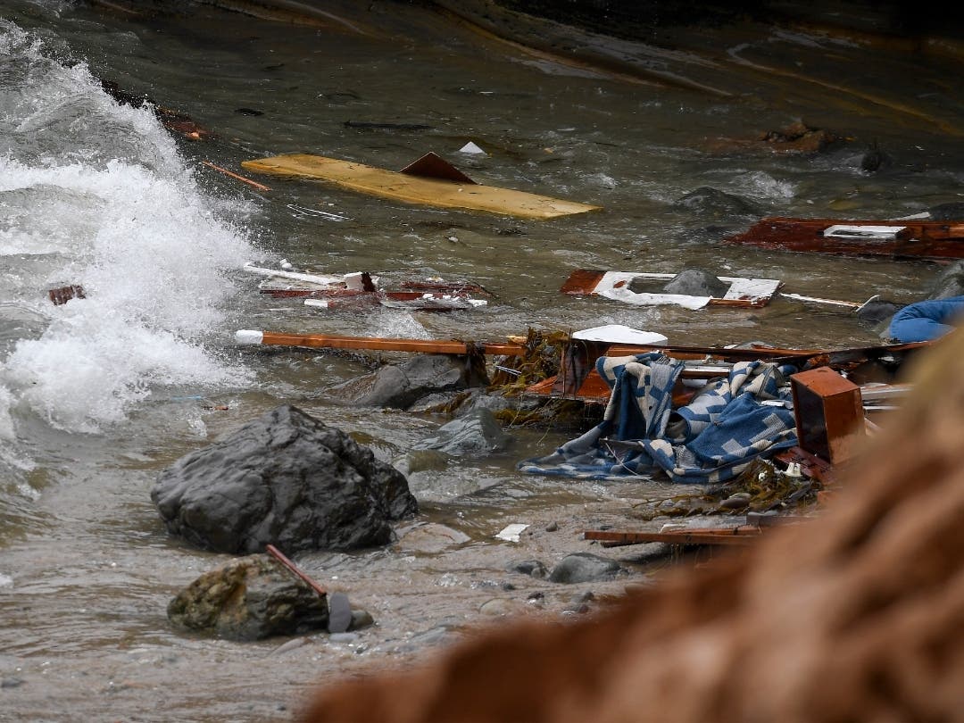 Wreckage and debris from a capsized boat washes ashore at Cabrillo National Monument near where a boat capsized just off the San Diego coast Sunday, May 2, 2021, in San Diego. 