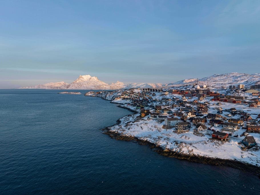 Houses are seen near the coast of a sea inlet of Nuuk, Greenland, on Sunday, Jan. 25, 2026. 