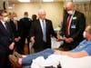 Vice President Mike Pence, center, visits a patient who survived the coronavirus and was going to give blood during a tour of the Mayo Clinic Tuesday, April 28, 2020, in Rochester, Minn.