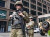 Members of the Minnesota National Guard stand at the intersection of South 7th Street and Nicollet Mall, Thursday, Aug. 27, 2020.
