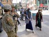 Minnesota National Guard soldiers chat as they stand watch along the famous Nicollet Mall, Thursday, Aug. 27, 2020,