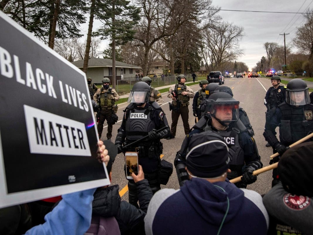 A National Guard soldier maintains watch at a shopping center in Brooklyn Center, Minn., a suburb of Minneapolis, Monday, April 12, 2021.
