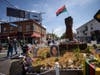 People walk through George Floyd Square after shots were fired on the one year anniversary of George Floyd's death on Tuesday, May 25, 2021, in Minneapolis. 
