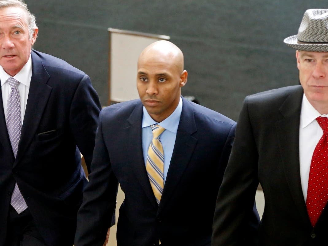 Mohamed Noor, center, accompanied by members of his legal team, arrives at the Hennepin County Government Center for a hearing Tuesday, May 8, 2018, in Minneapolis.