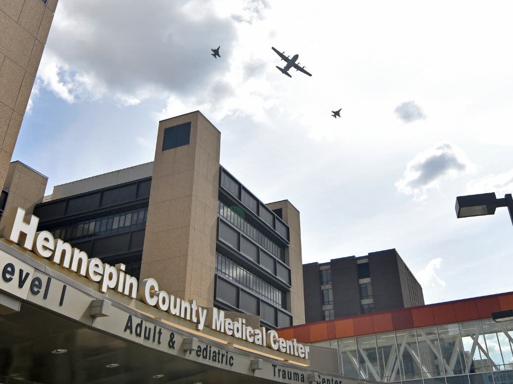 Two F-16s from the 148th Fighter Wing and a C-130 from the 133rd Airlift Wing fly over the Hennepin County Medical Center on May 6, 2020, in Minneapolis as part of Minnesota National Guard flyovers to show appreciation for all on the COVID-19 front lines.
