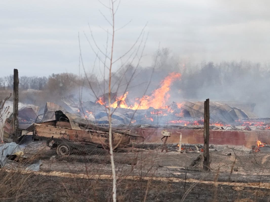 Flame and smoke rise from the debris of a private house in the aftermath of Russian shelling outside Kyiv, Ukraine, Thursday, Feb. 24, 2022. Russia on Thursday unleashed a barrage of air and missile strikes on Ukrainian facilities across the country.