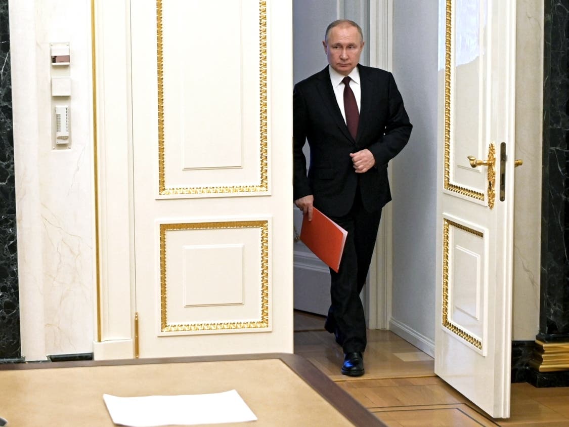 Russian President Vladimir Putin enters a hall to chair a Security Council meeting in Moscow, Russia, Friday, Feb. 25, 2022. 