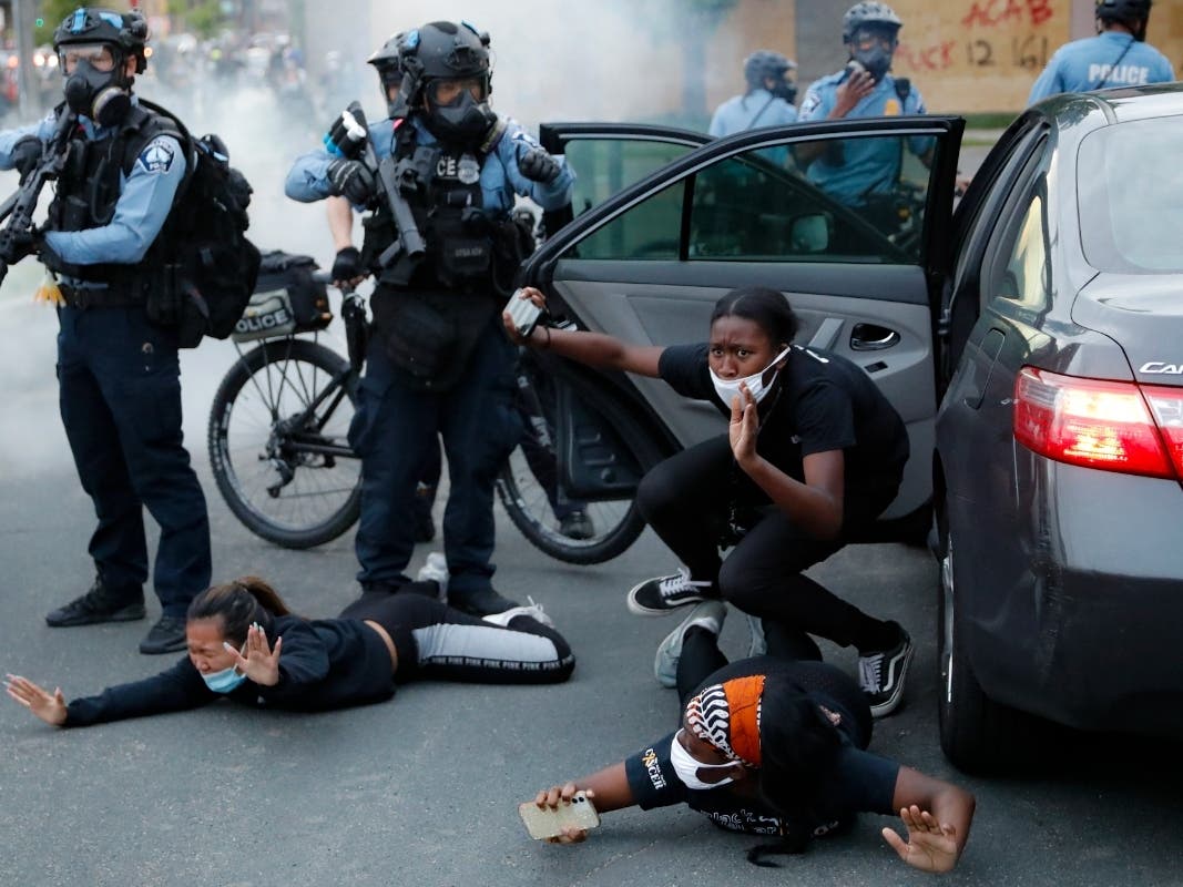 Motorists are ordered to the ground from their vehicle by police on May 31, 2020, during a protest in Minneapolis over the killing of George Floyd. 