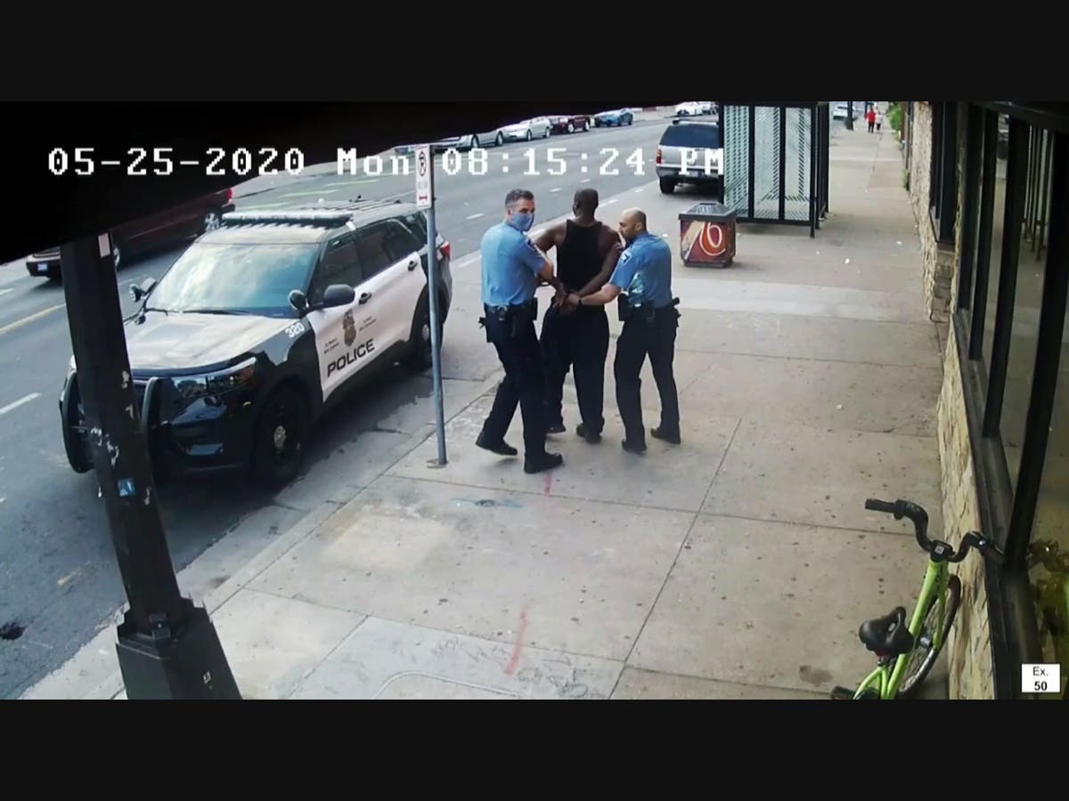 This image from video shows Minneapolis Police Officers Thomas Lane (left) and J. Alexander Kueng (right) escorting George Floyd to a police vehicle outside Cup Foods in Minneapolis on May 25, 2020.