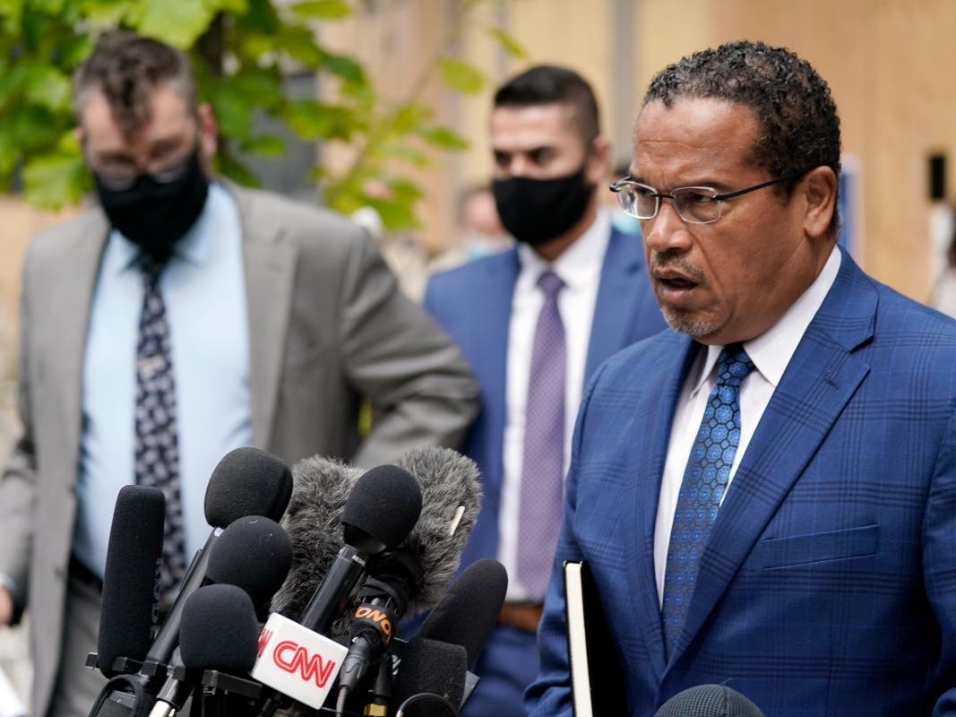 In this Sept. 11, 2020, file photo, Minnesota Attorney General Keith Ellison, right, addresses reporters outside the Hennepin County Family Justice Center in Minneapolis.