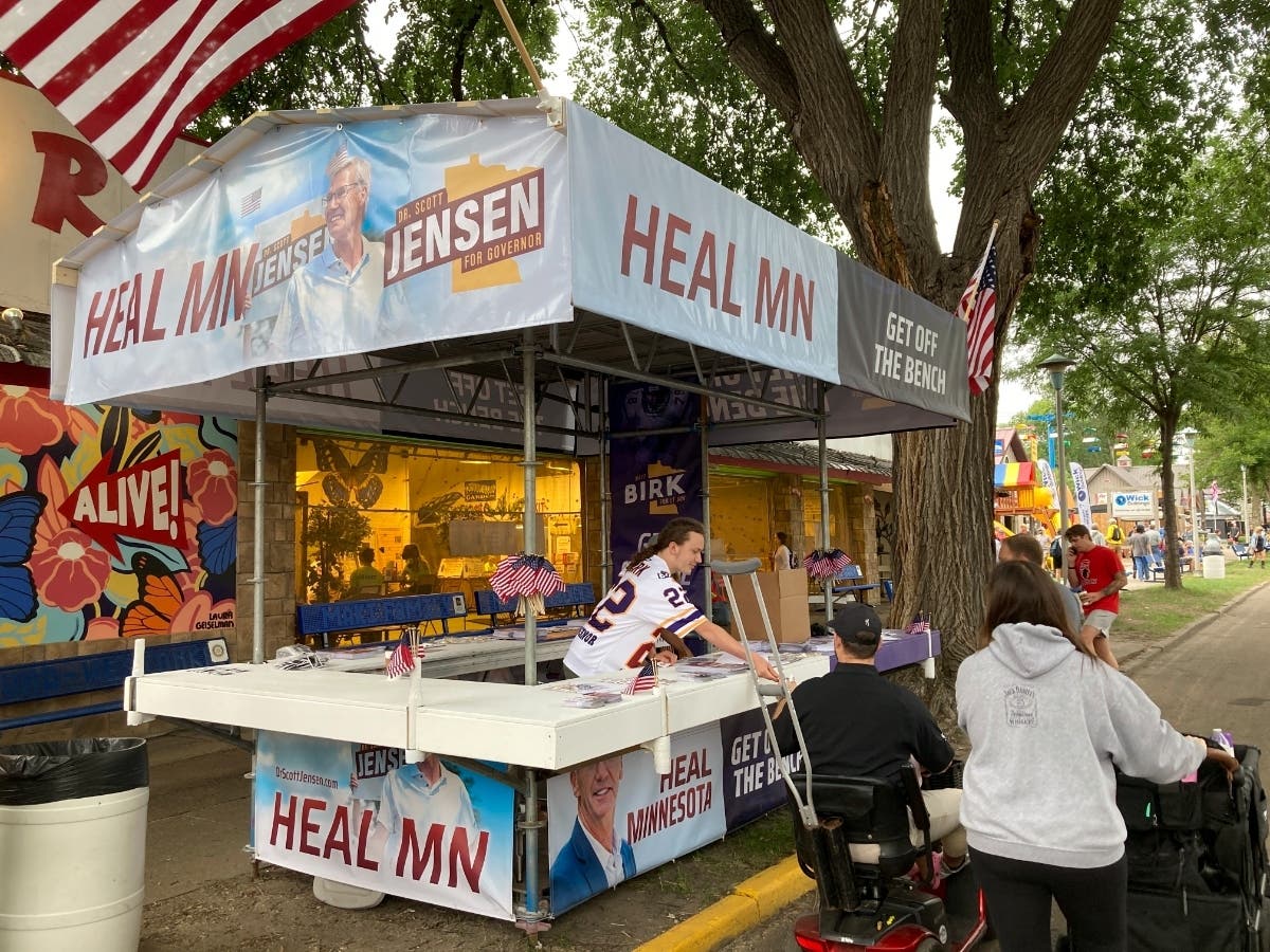 Campaign workers set up the booth for Republican gubernatorial candidate Scott Jensen on the opening day of the Minnesota State Fair on Thursday, Aug. 25, 2022, in Falcon Heights, Minn.