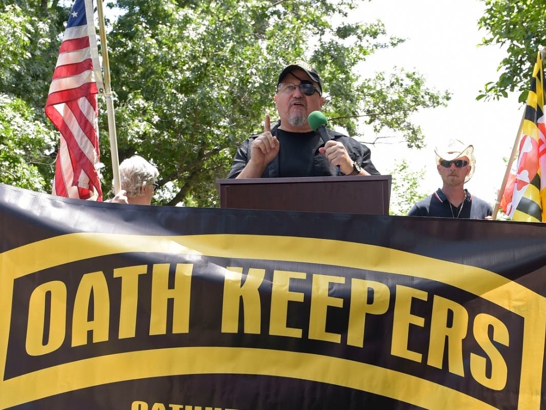 Stewart Rhodes, founder of the Oath Keepers, center, speaks during a rally outside the White House in Washington, June 25, 2017.