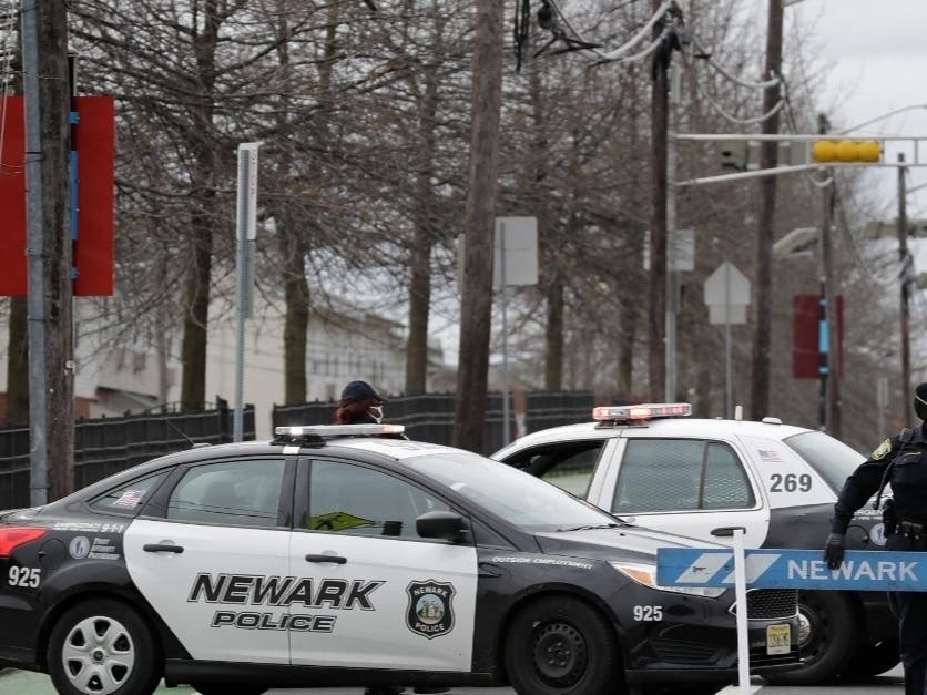 A police officer adjusts some barricades at an intersection on the border between Irvington and Newark, N.J., on April 3, 2020. Newark's police officers did not fire a single round at any point during 2020, while Brian O'Hara was public safety director.