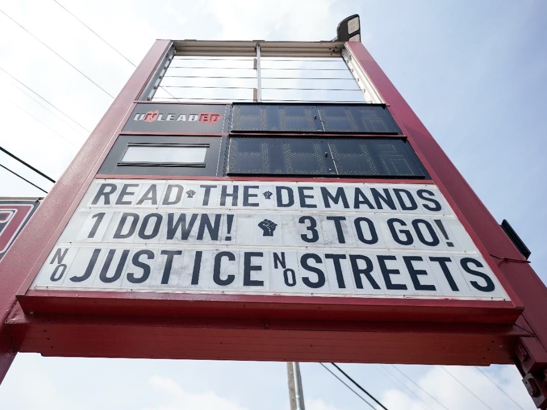 A sign is seen on a gas station's marquee near the site where George Floyd was killed by then Minneapolis Police officer Derek Chauvin, Thursday, June 24, 2021, in Minneapolis. Chauvin is scheduled to be sentenced Friday.