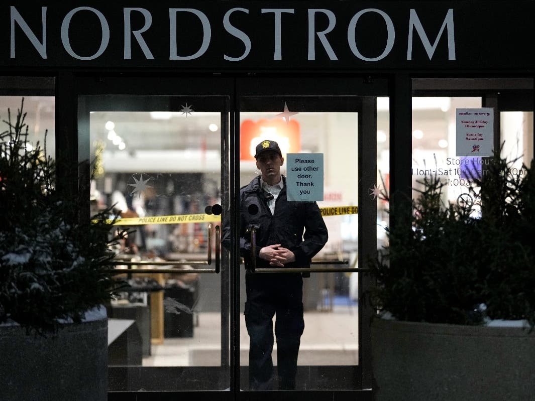 An officer stands inside Nordstrom at Mall of America after a shooting, Friday, Dec. 23, 2022, in Bloomington, Minn. 