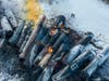 Firefighters stand near piled up train cars, near Raymond, Minn., Thursday, March 30, 2023, the morning after a BNSF freight train derailed.