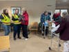 Linda Blackmore, executive director of the American Red Cross Minnesota Dakotas Region chapter, holds up a small gray dog while waiting with residents at Unity Christian Reformed Church in Prinsburg, Minn.