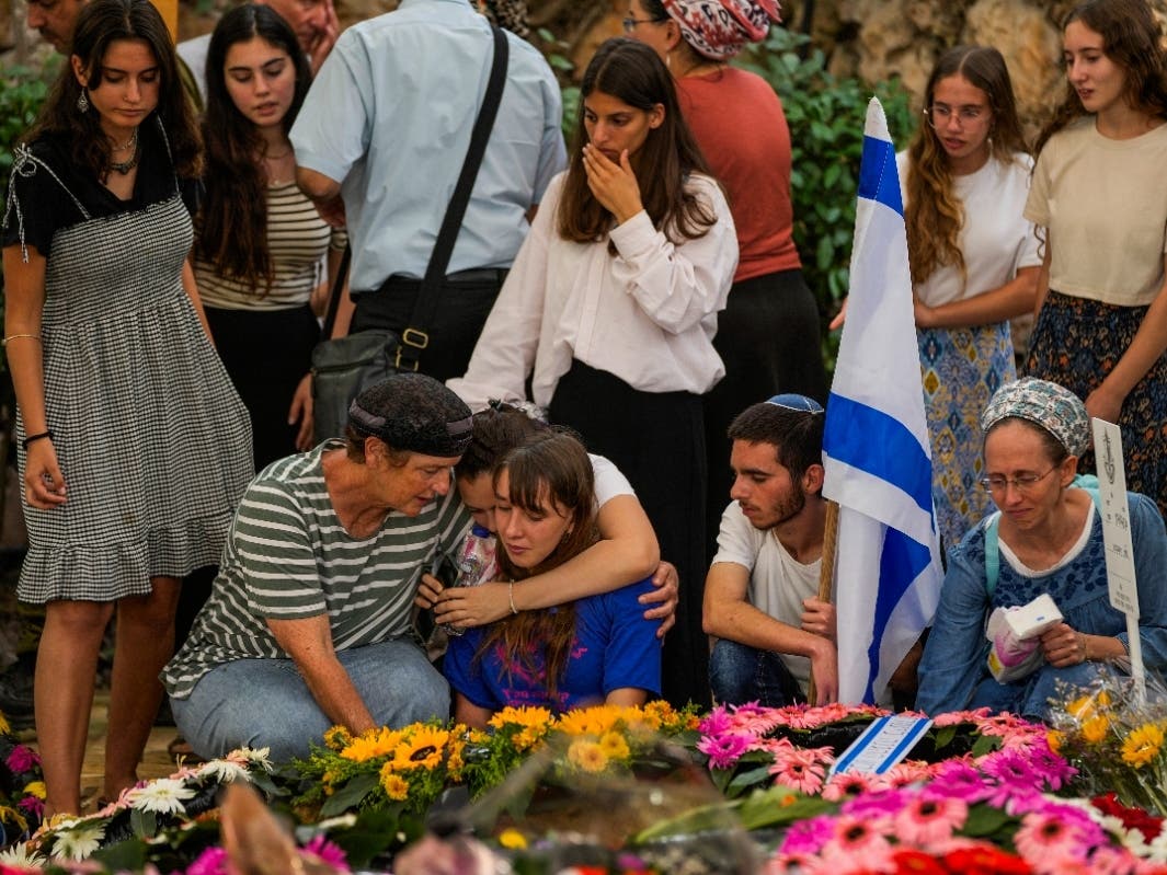 Mourners attend the funeral of Israeli soldier Shilo Rauchberger at the Mount Herzl cemetery in Jerusalem, Thursday, Oct. 12, 2023.